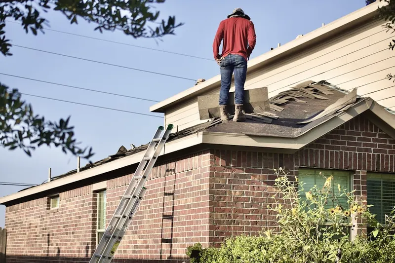 Professional roofer working on a residential roof in Forest Greens